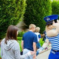 Woman high-fiving Louie the Laker